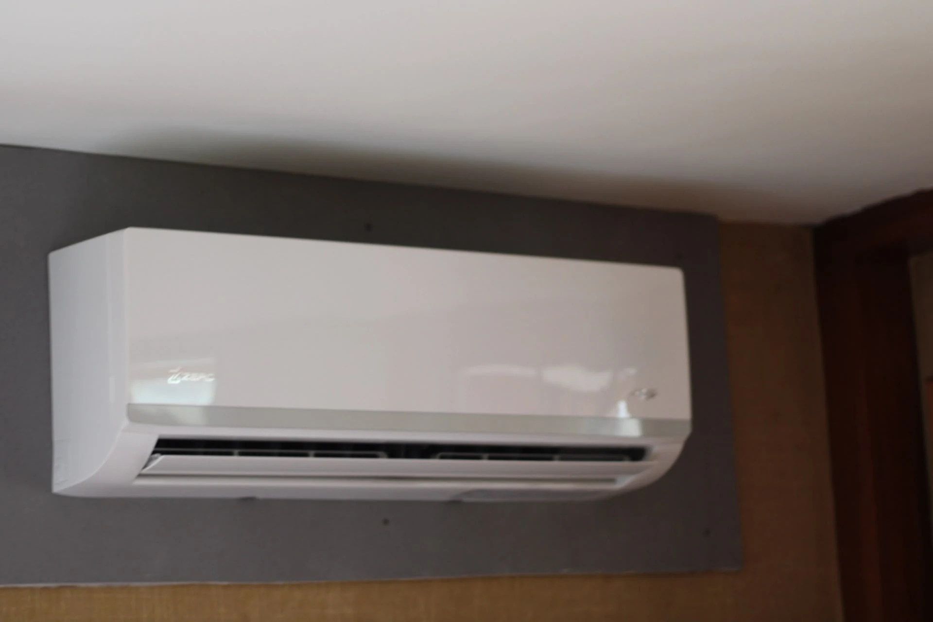 A wall-mounted indoor mini-split installed in a room under renovation